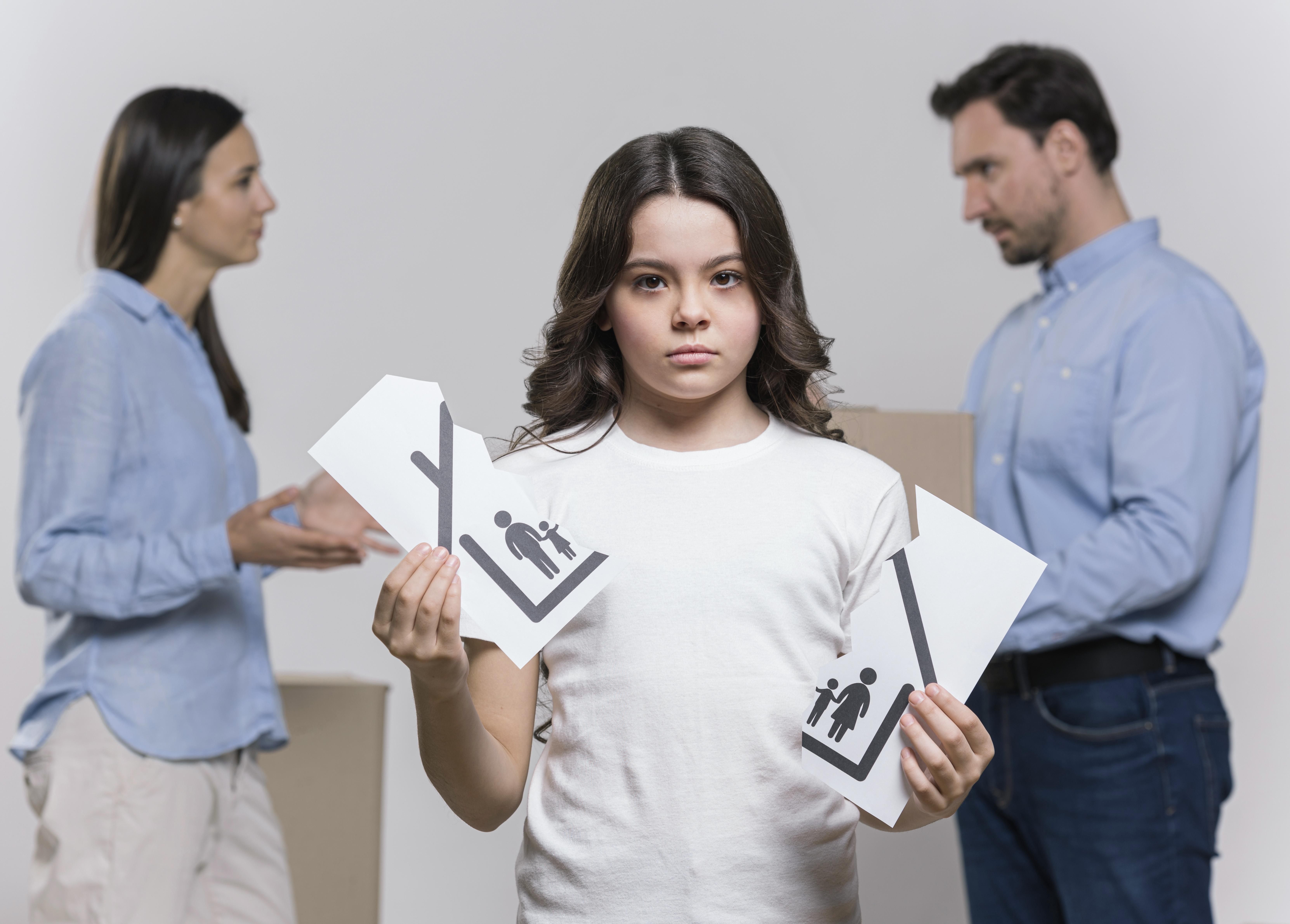 portrait sad girl with parents arguing