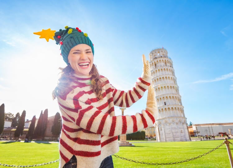 Mujer con gorro de navidad sosteniendo la Torre de Pisa